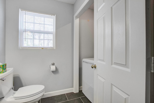 bathroom featuring tile floors and toilet