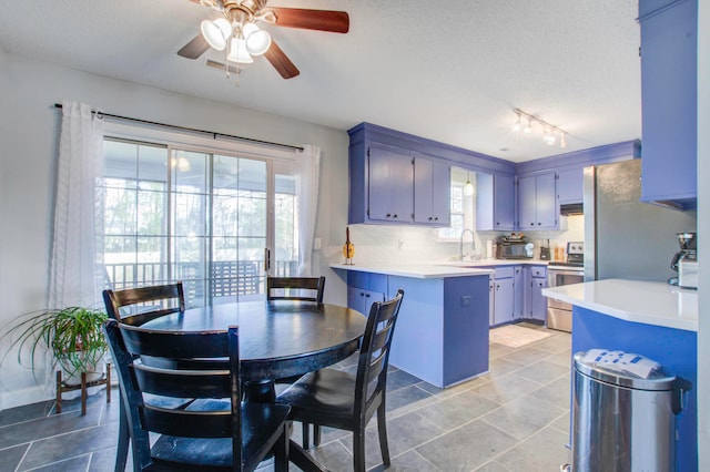 kitchen with ceiling fan, stainless steel electric range, tasteful backsplash, rail lighting, and light tile floors