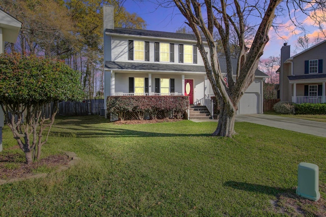 view of front facade featuring a garage, a porch, and a lawn