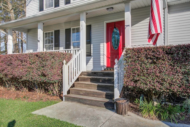 view of exterior entry with a porch