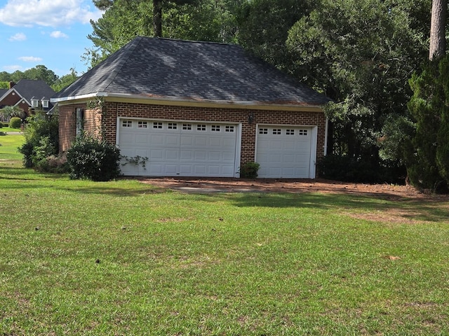 garage featuring a lawn