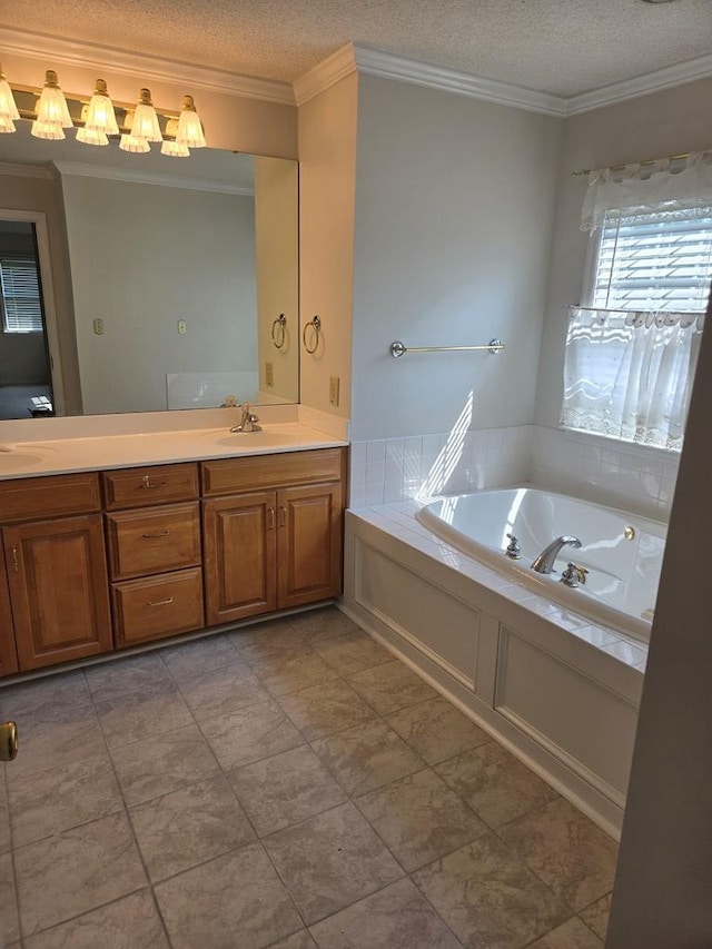 bathroom featuring vanity, a textured ceiling, ornamental molding, and a washtub