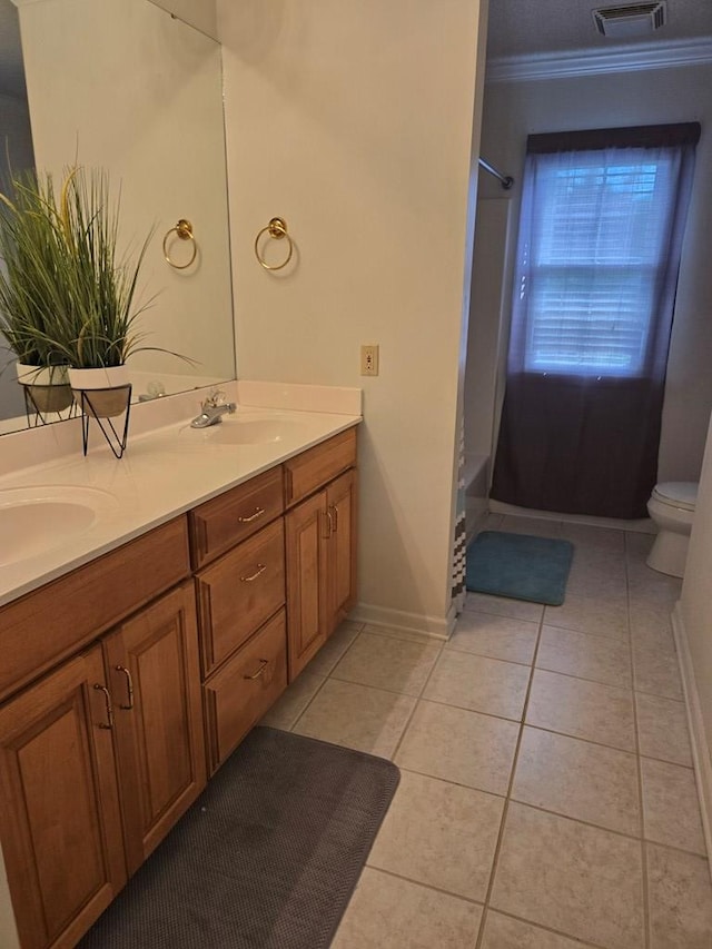 full bathroom featuring tile patterned flooring, toilet, crown molding, shower / washtub combination, and vanity