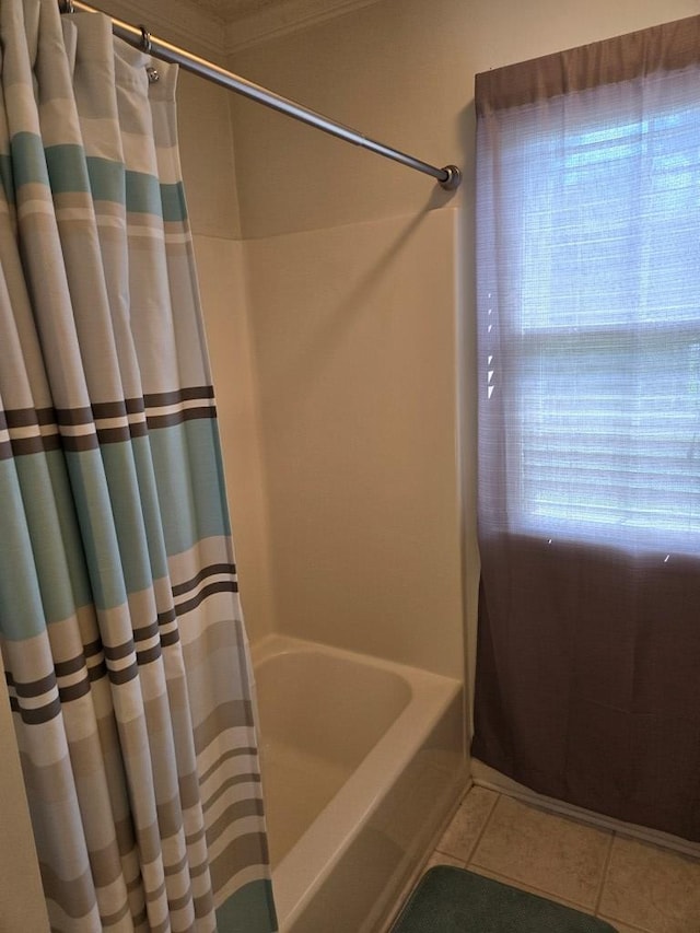 bathroom with tile patterned flooring and shower / tub combo