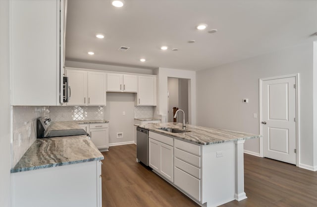 kitchen with dark wood-type flooring, a sink, white cabinetry, appliances with stainless steel finishes, and light stone countertops