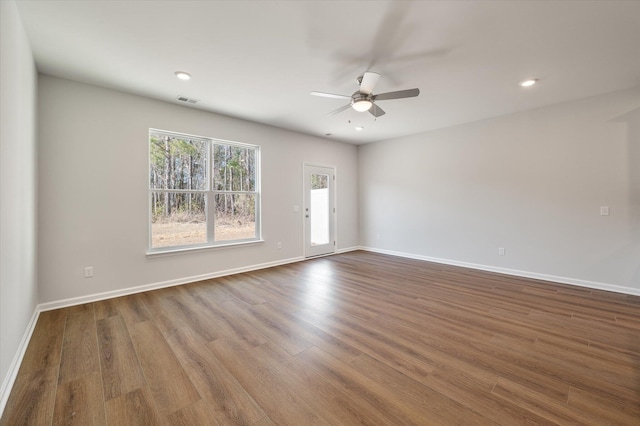 spare room with a ceiling fan, visible vents, wood finished floors, baseboards, and recessed lighting