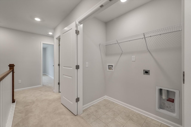 washroom featuring electric dryer hookup, light carpet, baseboards, hookup for a washing machine, and laundry area