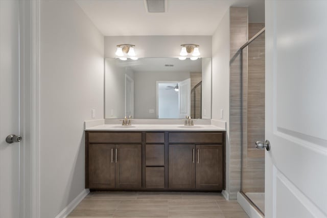 bathroom with a shower stall, visible vents, and a sink