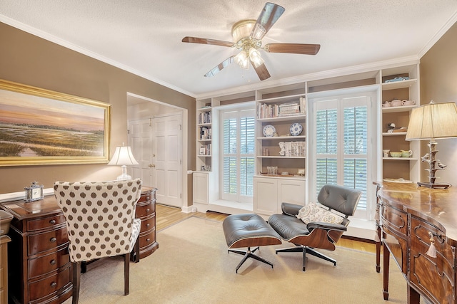 home office featuring crown molding, light wood-style flooring, ceiling fan, built in features, and a textured ceiling