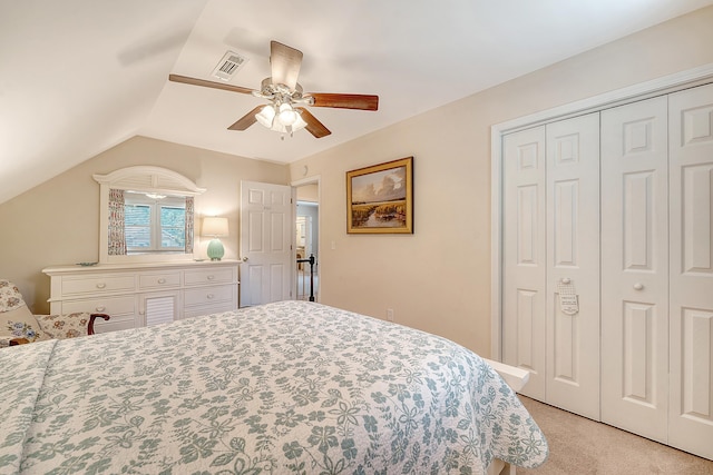 bedroom featuring light colored carpet, a closet, ceiling fan, and vaulted ceiling