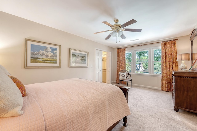 bedroom featuring light colored carpet, baseboards, and a ceiling fan