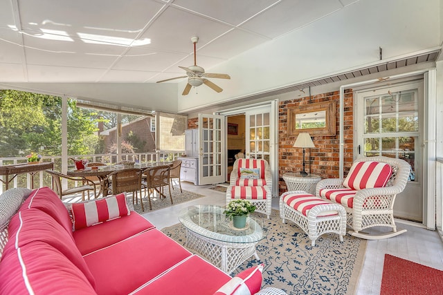 sunroom / solarium with ceiling fan, an outdoor hangout area, vaulted ceiling, and outdoor dining area
