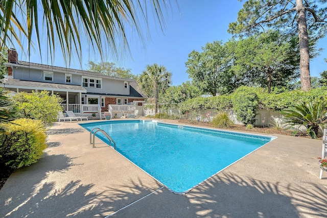 view of pool with fence and a patio