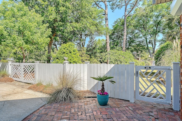 view of patio with a gate and fence
