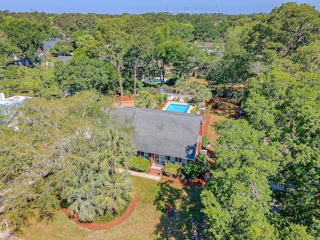 view of subject property featuring a heavily wooded area