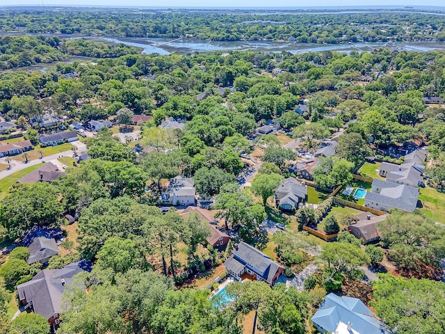 view of property location featuring a nearby body of water and nearby suburban area