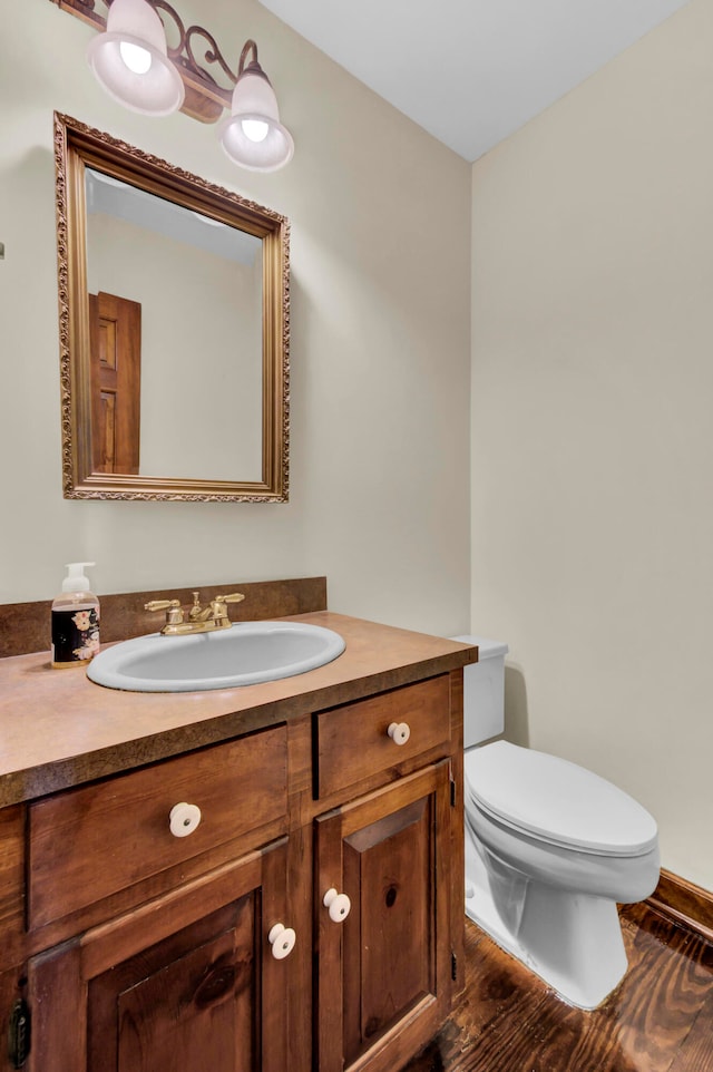 bathroom featuring toilet and vanity