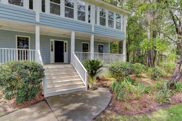 view of exterior entry with covered porch