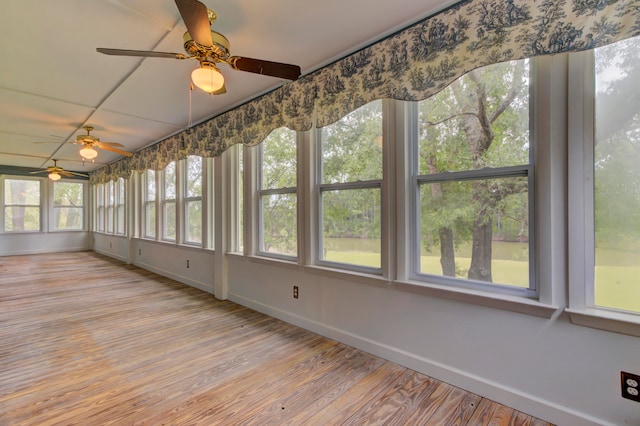 unfurnished sunroom with ceiling fan and a healthy amount of sunlight