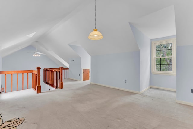 additional living space featuring ceiling fan, lofted ceiling, and light colored carpet