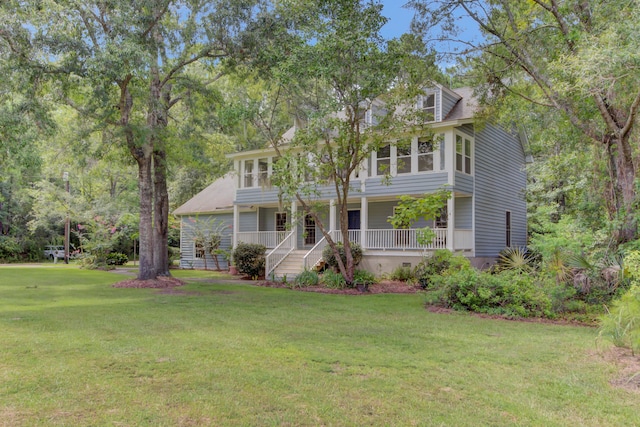 view of front of home with covered porch and a front yard