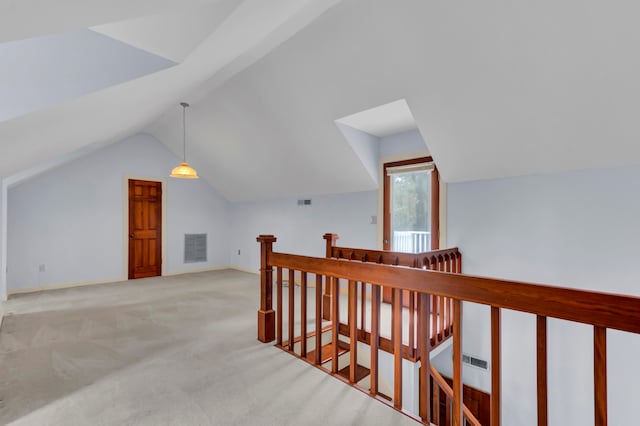 bonus room with lofted ceiling and light colored carpet