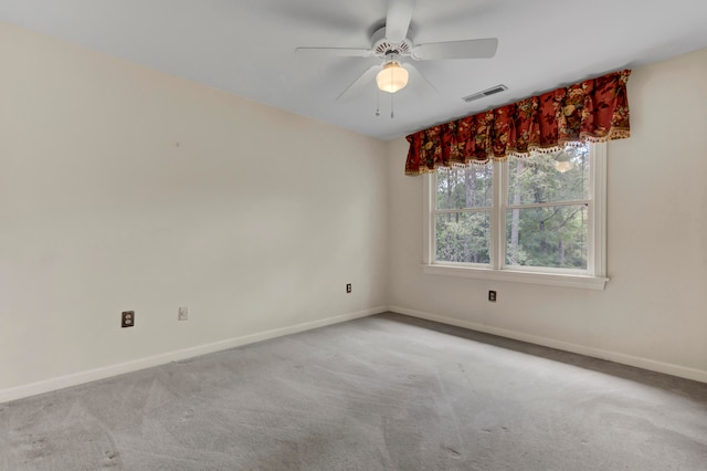 unfurnished room with ceiling fan and light carpet