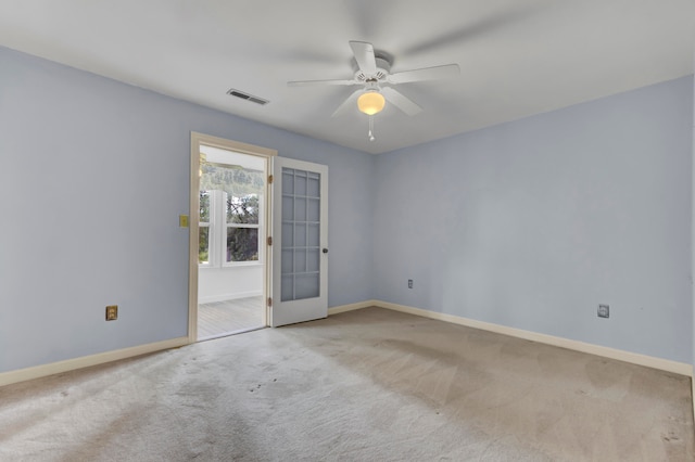 carpeted empty room featuring ceiling fan