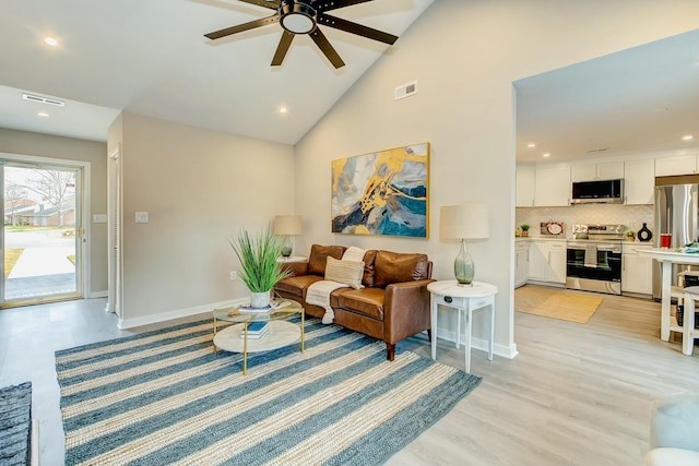 living area with light wood finished floors, baseboards, and visible vents