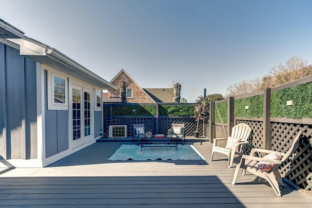 deck featuring central air condition unit and french doors