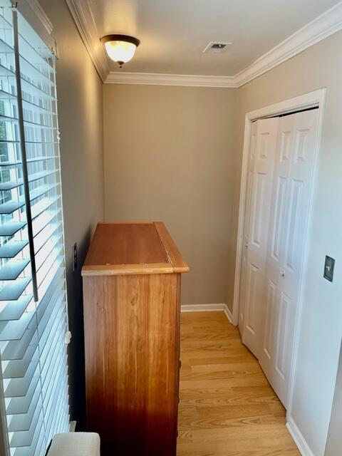 interior space featuring light hardwood / wood-style floors and ornamental molding