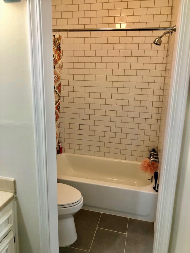 full bathroom featuring tile patterned flooring, vanity, toilet, and shower / tub combo