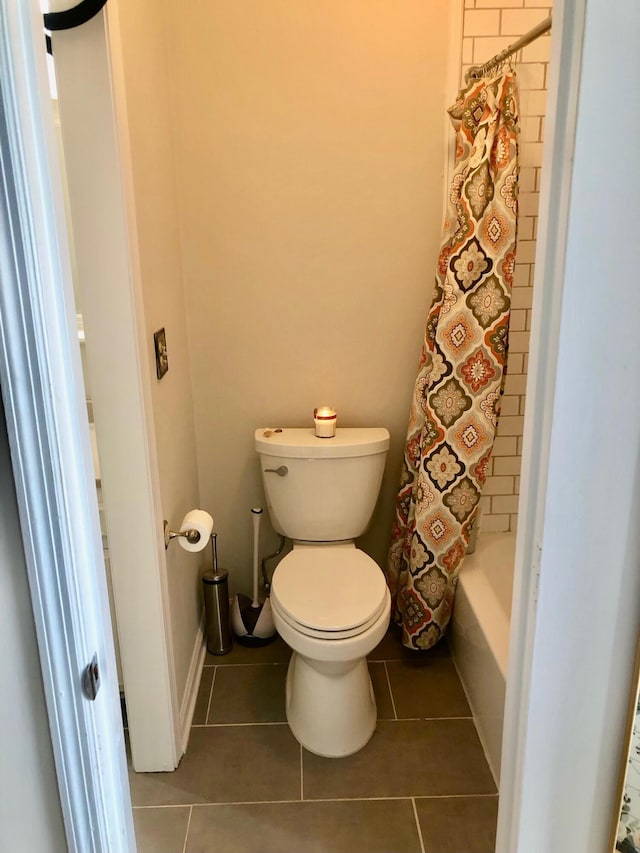 bathroom featuring toilet, shower / bath combo, and tile patterned floors