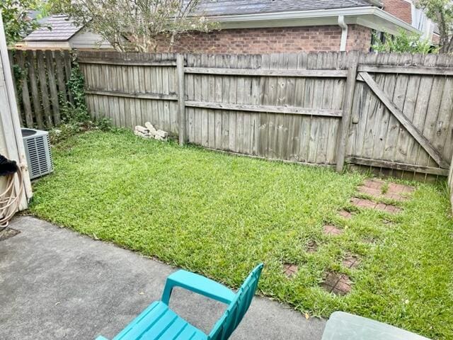 view of yard featuring a patio area and central AC