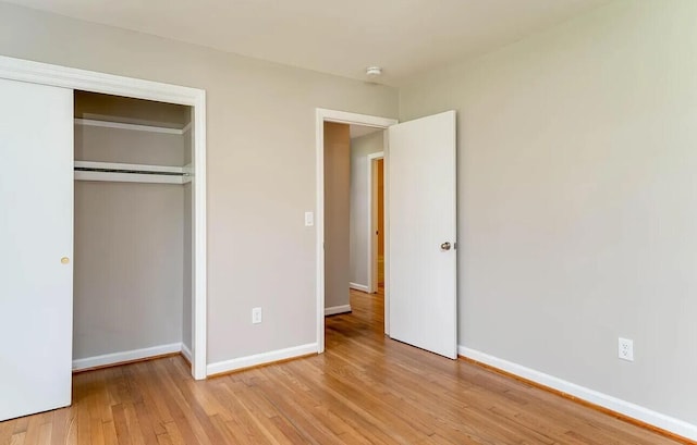 unfurnished bedroom featuring light hardwood / wood-style floors and a closet