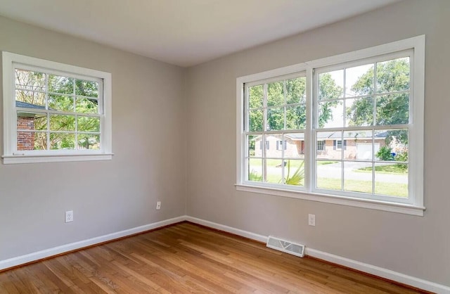 unfurnished room with light wood-type flooring