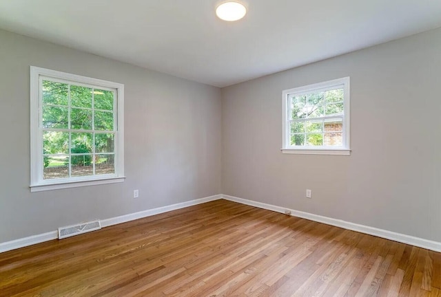 unfurnished room with light wood-type flooring