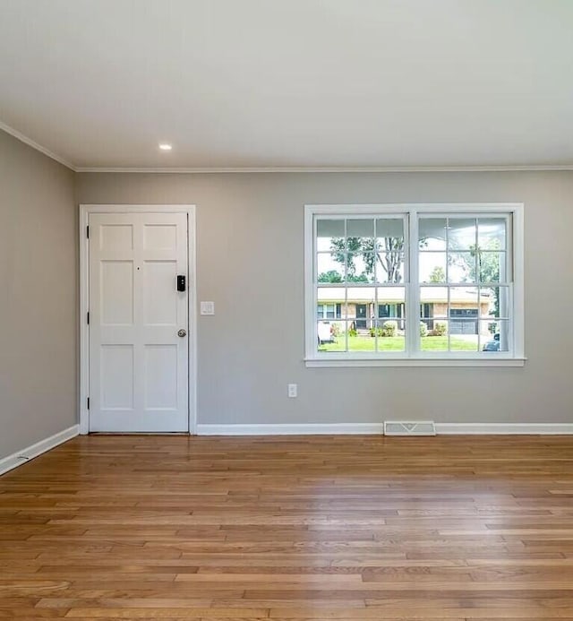 entrance foyer with light wood-type flooring and ornamental molding