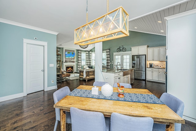 dining space with wooden ceiling, sink, crown molding, dark hardwood / wood-style flooring, and vaulted ceiling