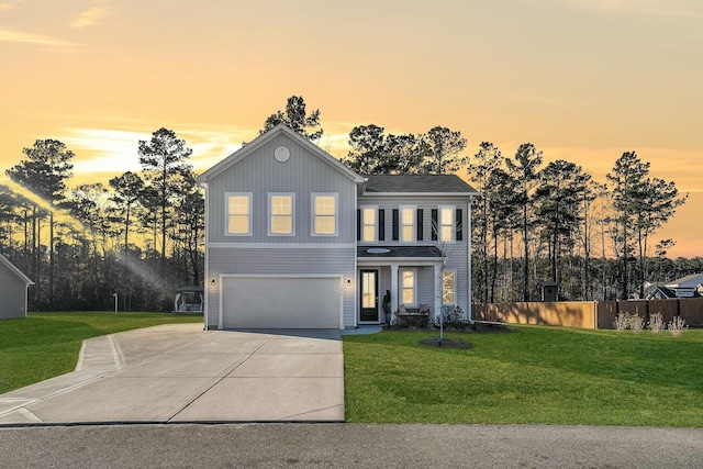 view of front of property with a garage and a lawn