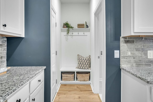 mudroom with light hardwood / wood-style floors