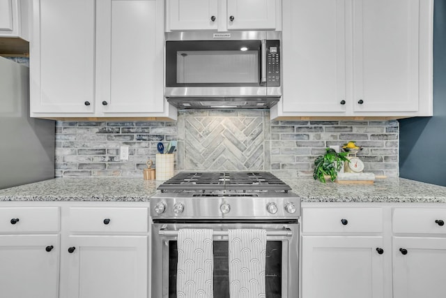 kitchen featuring stainless steel appliances and white cabinets