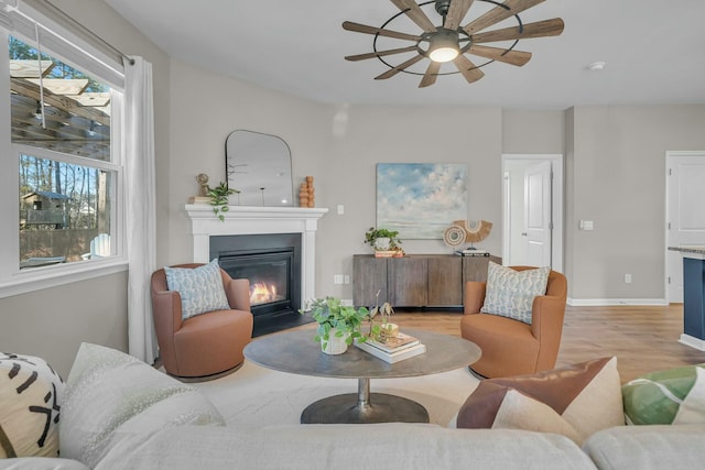 living room featuring ceiling fan and light wood-type flooring