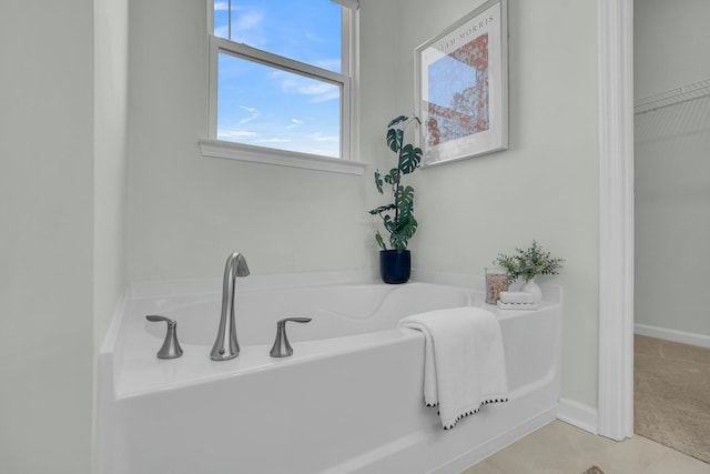 bathroom featuring a washtub and tile patterned floors