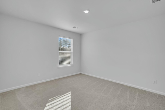 empty room featuring light colored carpet