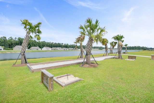 view of community with a lawn and a water view