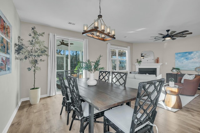 dining room with ceiling fan and light hardwood / wood-style floors