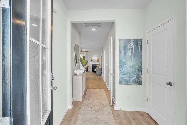 corridor with light hardwood / wood-style flooring