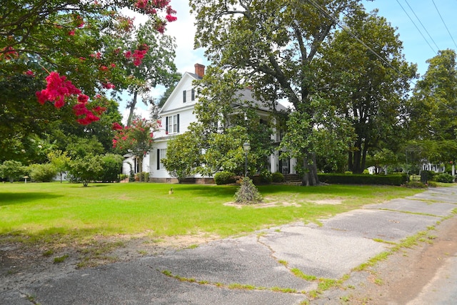 view of front of property featuring a chimney and a front lawn