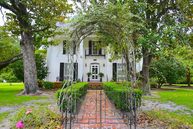 view of front of property featuring french doors and a balcony